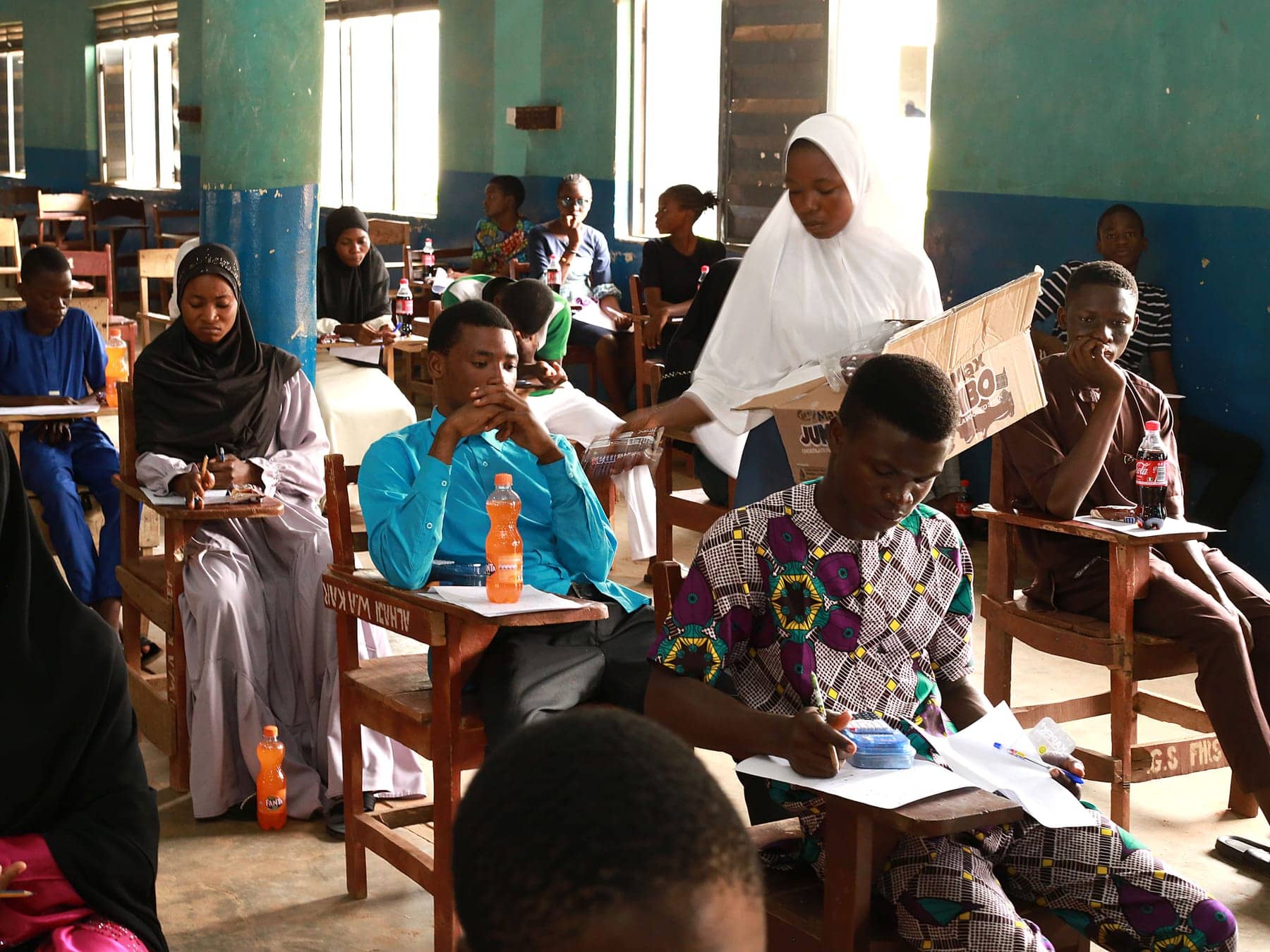Applicants sit the Brilliant Students' Scholarship screening test in a village school hall